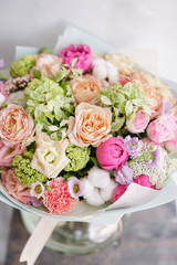 Floristry concept. Bouquet of beautiful flowers on gray table. Spring colors. the work of the florist at a flower shop.