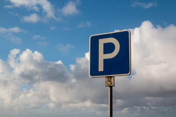 Parking traffic sign and a sky with clouds