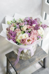 Floristry concept. Bouquet of beautiful flowers on gray table. Spring colors. the work of the florist at a flower shop.