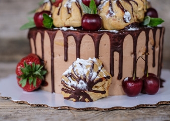 homemade profiterole cake with strawberries and cherries