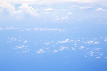 Naklejka na ściany i meble Aerial view from airplane window with sky clouds