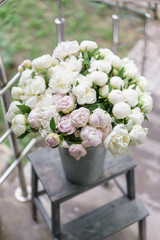 Beautiful bouquet of white and pink peonies . Floral composition, daylight. Wallpaper. Vertical photo