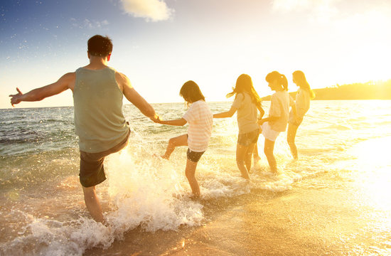 Happy Family Having Fun On The Beach