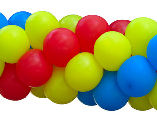 Red, blue and yellow celebration balloons in stack isolated