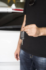 hand holding a car key.