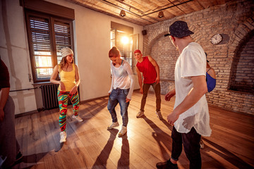 young hip hop dancers dancing in the studio. Sport, dancing and urban culture concept