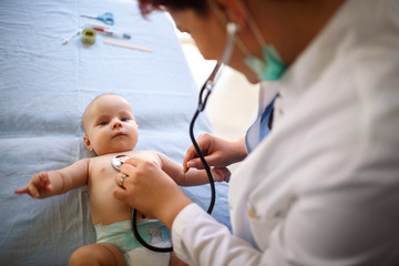 Baby is examined by pediatrician