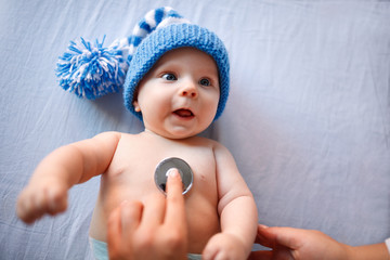 Cute baby on preventive pediatric examination © luckybusiness