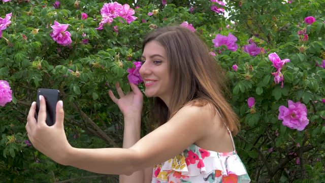 Young Beauty Woman Selfie With Flowers Sitting On Bench