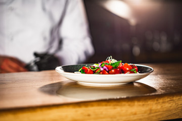 Closeup mid section of a chef putting salt in the kitchen