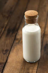 milk glass bottle on wood
