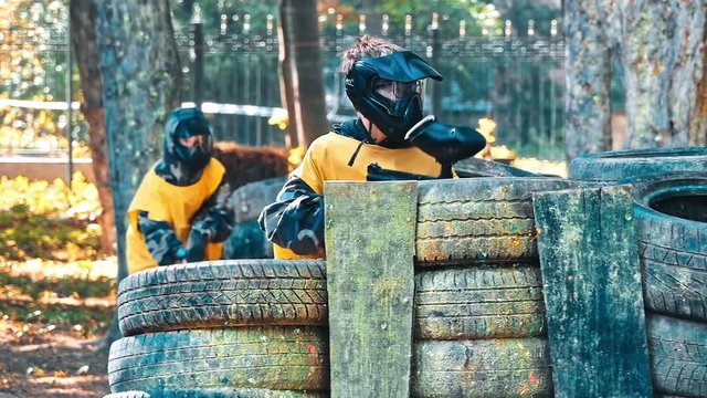 Paintball player in protective uniform and mask