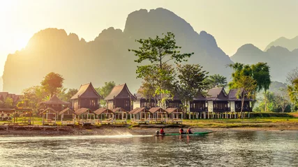 Foto op Canvas Village and bungalows along Nam Song River in Vang Vieng, Laos. © tawatchai1990