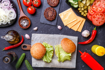 Photo on top of two hamburgers and ingredients