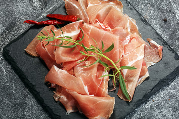 Italian prosciutto crudo or jamon with parsley. Raw ham
