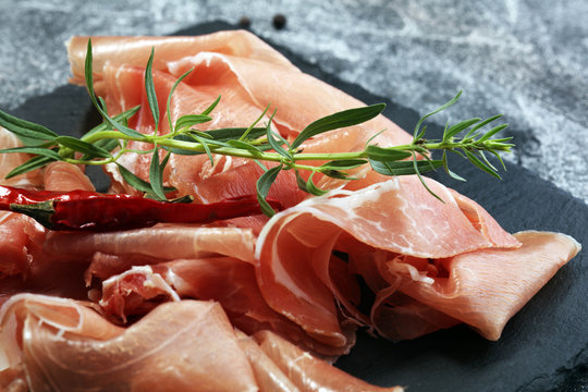 Italian prosciutto crudo or jamon with parsley. Raw ham