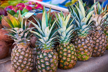 pineapple on the italian street od Corniglia. fresh organic vegetables in wooden box.