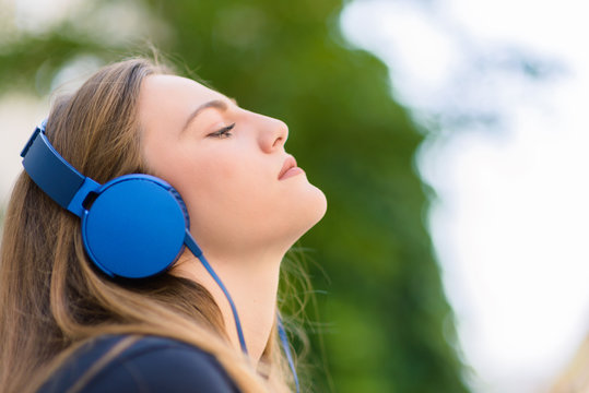 Portrait Image Of A Girl Who Wearing Blue Headphones
