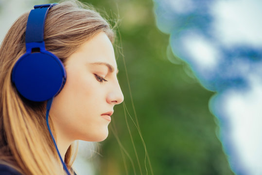 Cute girl enjoying in the music through headphones