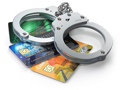 Credit card with handcuffs isolated on white background.  Banking financial crime  and accounting fraud concept.