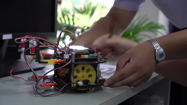 Learning STEM Education robotics project concept: Asian Student group creating and studying for innovation robot model ipst that Study generation for DIY electronic Kit in 21st education classroom