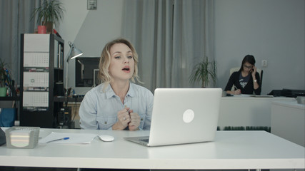 Attractive recruiter conducting job interview using laptop