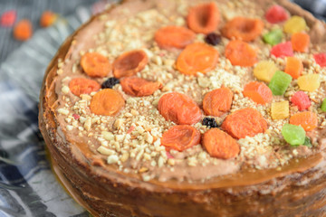 Homemade air-nut cake with chocolate cream, boiled condensed milk, candied fruit, nuts and dried...