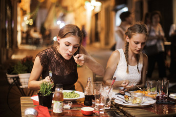 Beautiful girls eating dinner