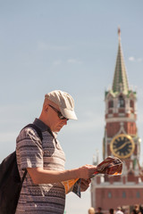 Fototapeta premium One tourist is looking at the map in the Red Square