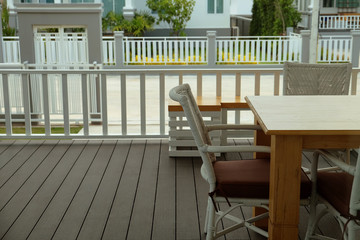 House balcony at ground floor with wood table and chairs