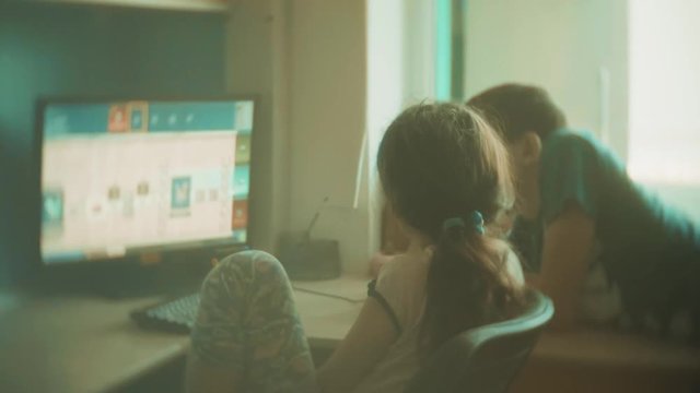 children play computer in video games. boy and girl kids play online video games slow motion the video. kids lifestyle play video game concept