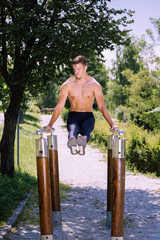 Fototapeta premium Young male fitness model exercise outdoor