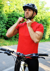 Bicyclist puts on a helmet