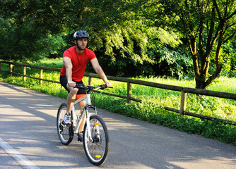 Fototapeta premium Cyclist riding a bike in the park