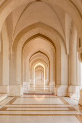 Fototapeta na wymiar A stunning marble corridor with reflecting arches in Muscat - 1