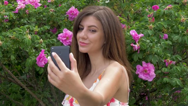 Young Beauty Caucasian Woman Selfie With Flowers And Smiling