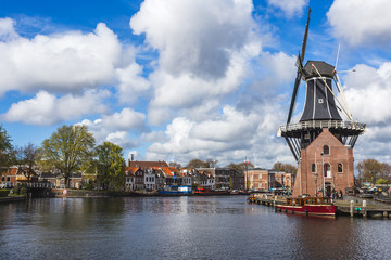 View of Windmill De Adriaan reflected in the canal of the river Spaarne Haarlem North Holland The Netherlands Europe