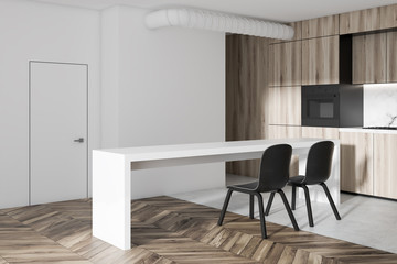 Fototapeta na wymiar White and wooden kitchen corner in a studio flat