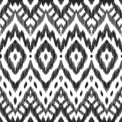 The ornamental ikat pattern on ethnic style. Vector illustration in black and white colors. Exquisite seamless texture can be perfect for background images, wallpapers, textiles, wrapping papers.