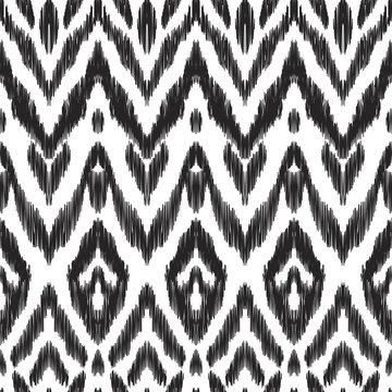 The intricate ikat pattern on ethnic style. Vector illustration in black and white color palette. Exquisite seamless texture can be perfect for background images, wallpapers, textiles, wrapping papers