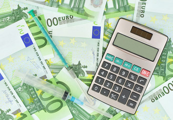 medical syringes, calculator and euro money