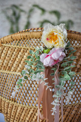 Beautiful flowers on a wicker chair