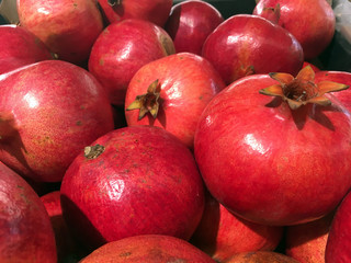 red ripe pomegranate on the counter of the store, summer collection