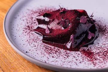 Creative Fine Dinning: Sliced beetroot wrap with goat cheese, blackberry and walnut served with bread.