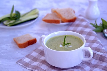 Summer cold yoghurt soup with fresh cucumber, green peas and mint 