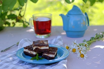 Sweet dessert, chocolate brownie with a layer of cream cheese