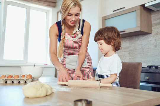 Mother And Son Bake Cakes In The Kitchen.