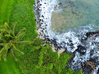 Aerial view of a black volcanic rock beach in Wailea, Maui, Hawaii