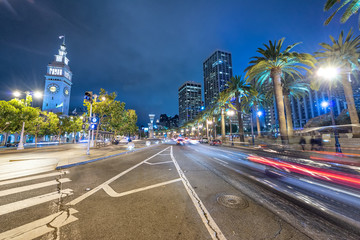 Streets of San Francisco at night in Embarcadero area with city traffic