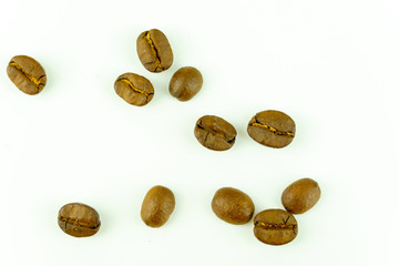 close up of medium or dark roasted coffee beans isolated on white background, can be used as a background or graphic object in your ads.
